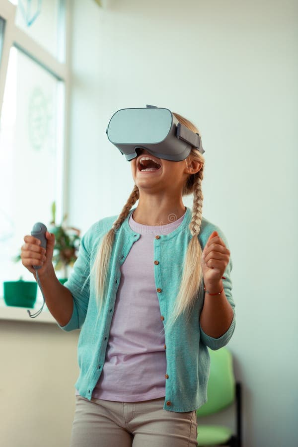 Happy girl being excited winning virtual game. royalty free stock photo