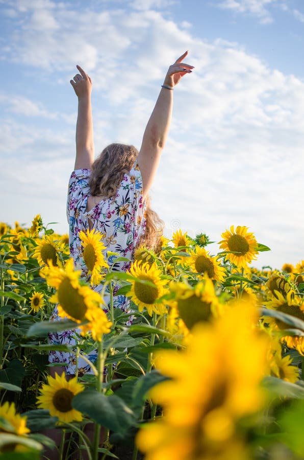Happy Girl with Blond Long Hair on a Field of Sunflowers Stock Photo ...