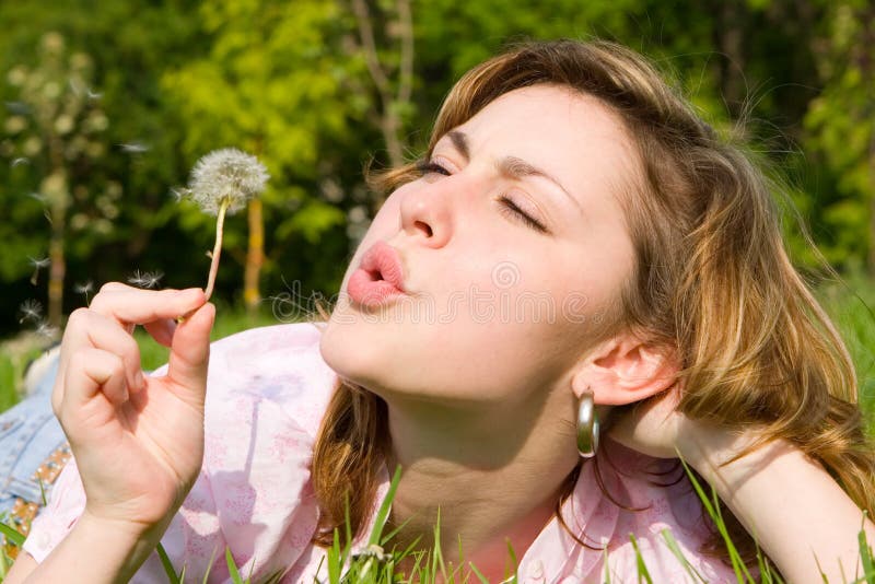 Happy girl blowing