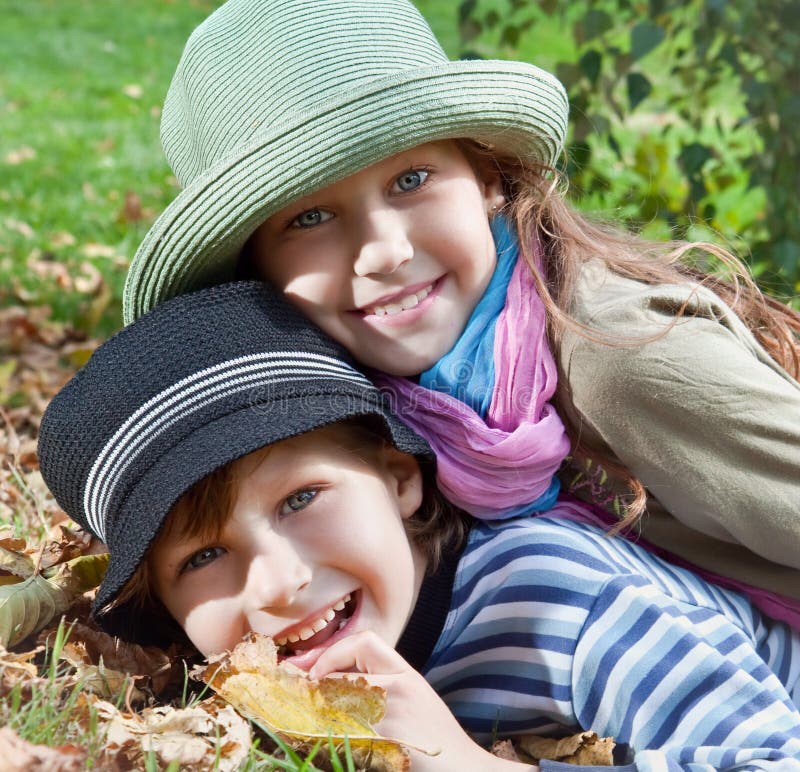 Happy girl and boy enjoying autumn season