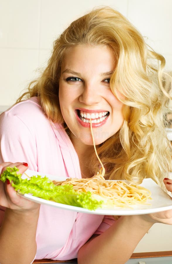 Happy girl eating spaghetti