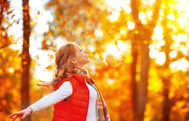 Happy Woman Enjoying Life in the Autumn on the Nature Stock Photo