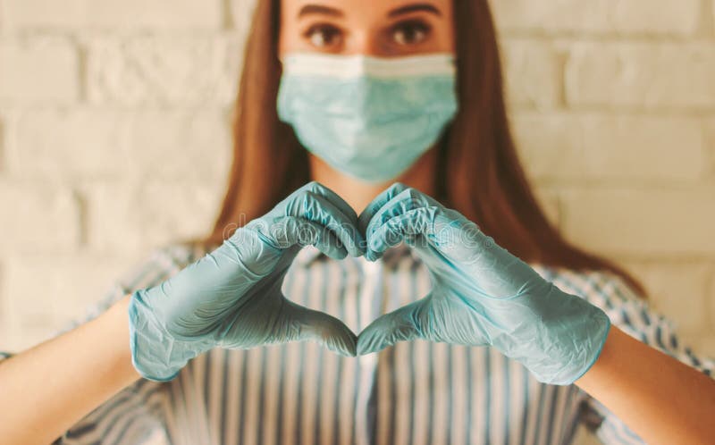 happy-girl-gesturing-heart-love-sign-hands-gloves-woman-protective-medical-face-mask-holds-form-symbol-young-185369822.jpg