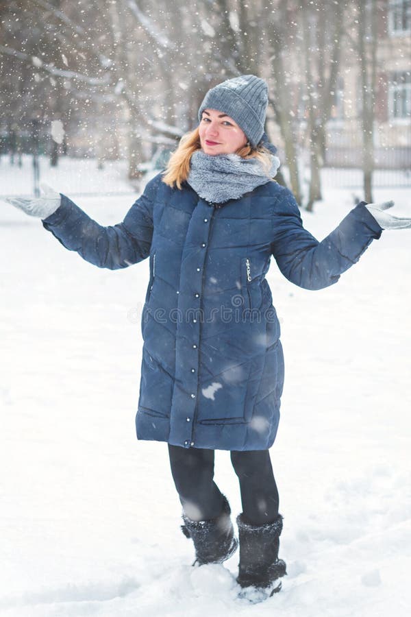 Happy girl in her yard in winter stock image Happy girl in her yard in winter stock image