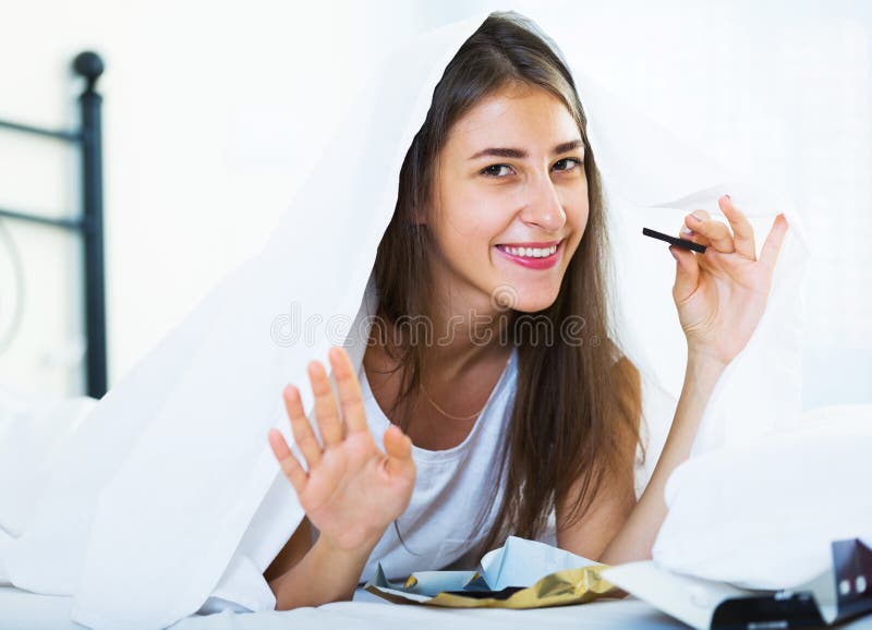 Happy Girl Hiding Under Sheet With Sweets Indoors Stock Image Image