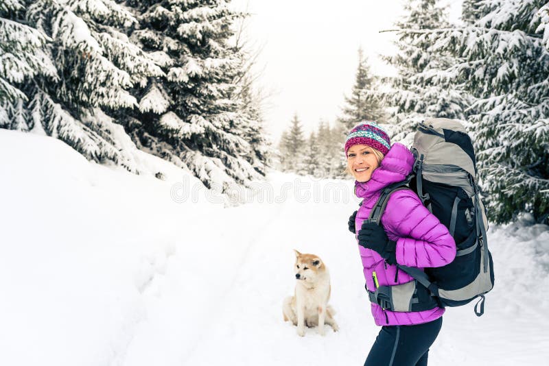 A Girl in Hiking Clothes with Trekking Poles Walks in the