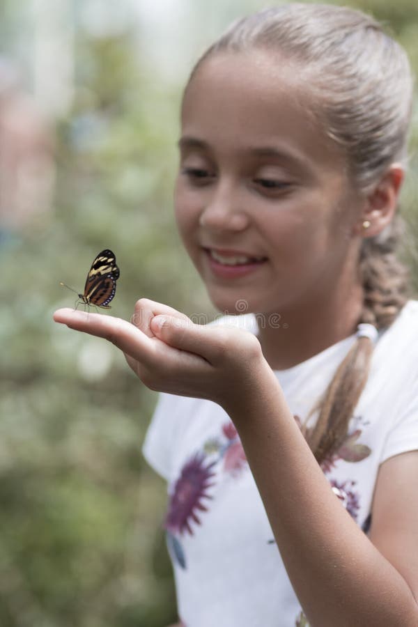 Happy Girl Holding a Butterfly