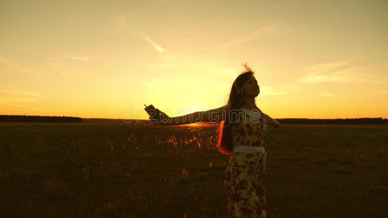 Happy Girl Listening To Music And Dancing In The Rays Of A Beautiful