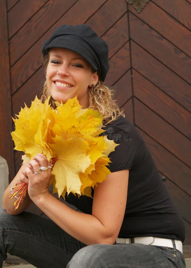 Happy girl with maple leaves