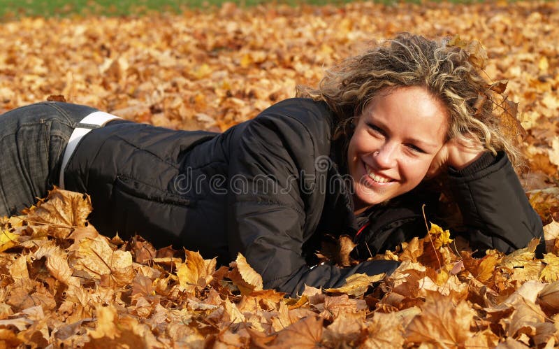 Happy girl in maple leaves