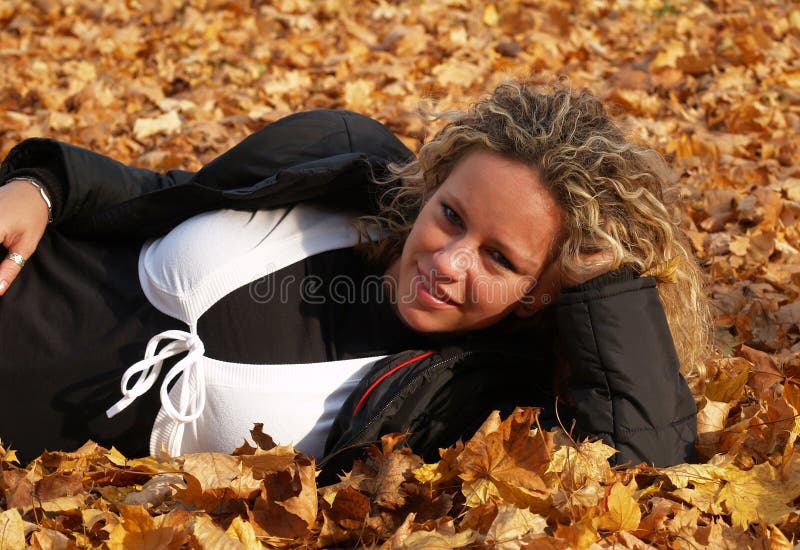 Happy girl in maple leaves