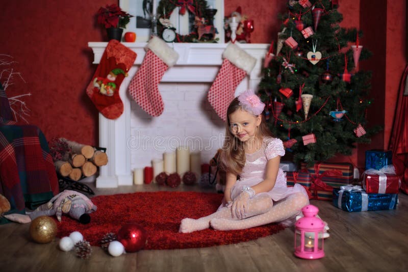 Happy girl near Christmas tree