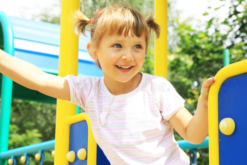 Happy girl playing on the playground