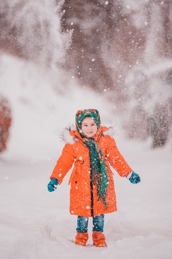 A Happy Girl In A Red Jacket And Ukrainian National Kerchief Walks In A