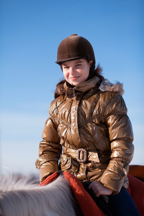 Happy girl riding horse