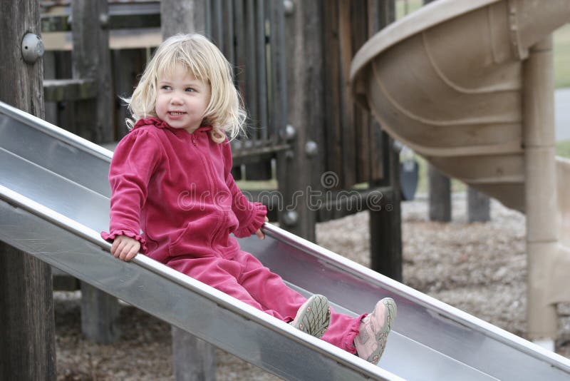 Happy Girl on Slide at Playground 2