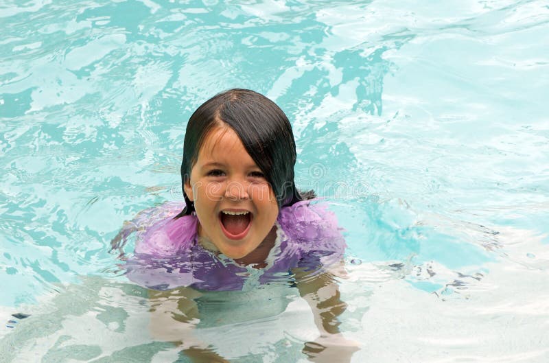 Young girl swimming happily in an outdoor swimming pool Check out my. Young girl swimming happily in an outdoor swimming pool Check out my