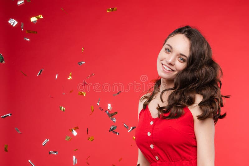 Happy girl wearing red dress looking at camera