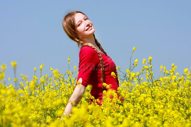 Happy girl in yellow flowers