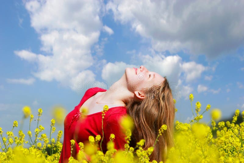 Happy girl in yellow flowers