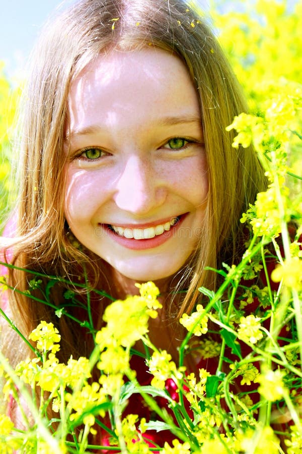 Happy girl in yellow flowers