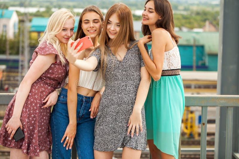 Four Happy Girlfriends Take a Selfie on a Smartphone Stock Image ...
