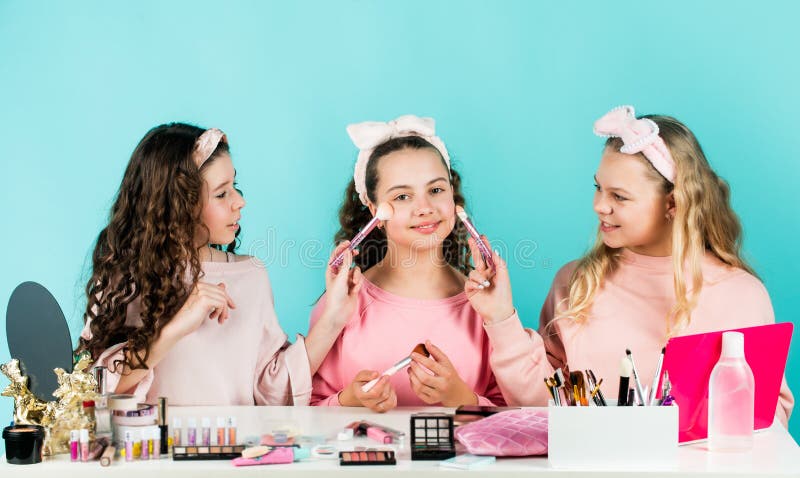 Happy girls doing makeup together. Sisterhood happiness. Cosmetics shop. Apply powder. Cream base tone. Prevent acne. Kids makeup. Skin care concept. Cosmetics for children. Beauty and fashion.