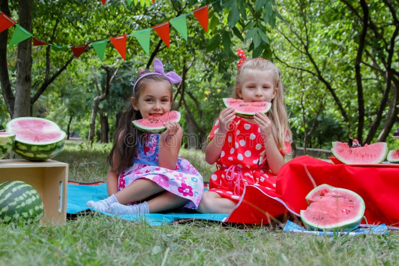 Happy girls eating watermelons