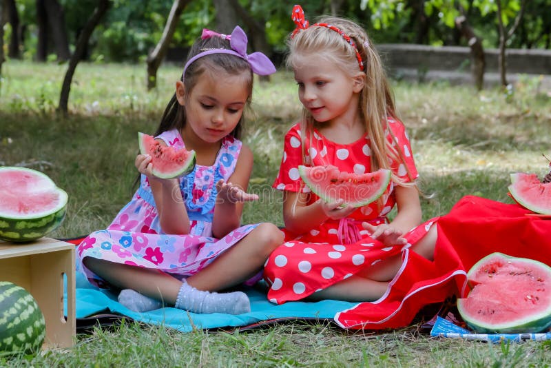 Happy girls eating watermelons