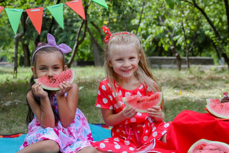 Happy girls eating watermelons