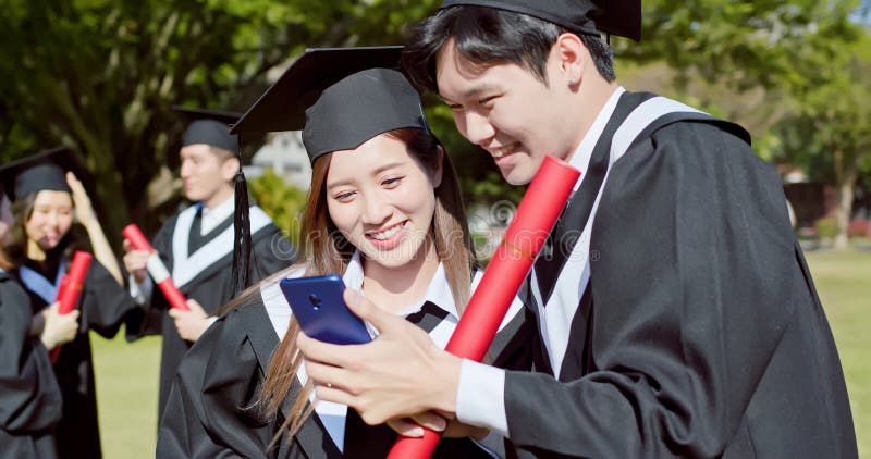 Happy graduate friends take selfie stock images