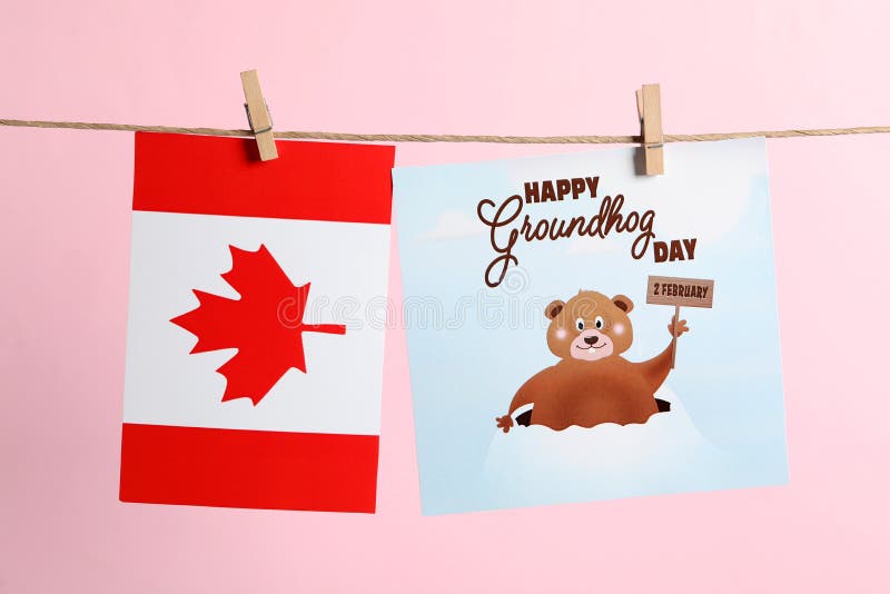 Happy Groundhog Day greeting card and Canada flag hanging on pink background