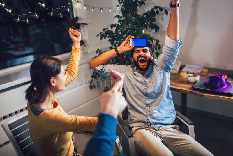 Happy group of friends playing charades at home stock photography Happy group of friends playing charades at home stock photography