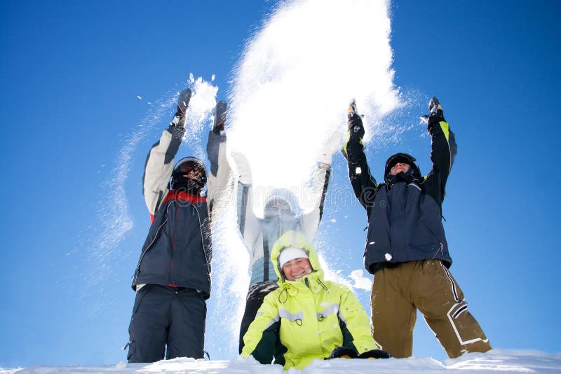 The happy group of people throws a snow