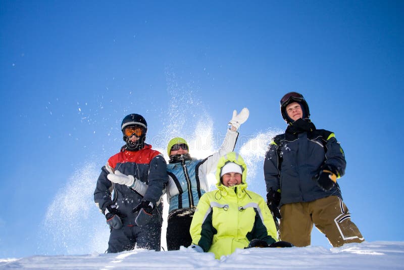 The happy group of people throws a snow