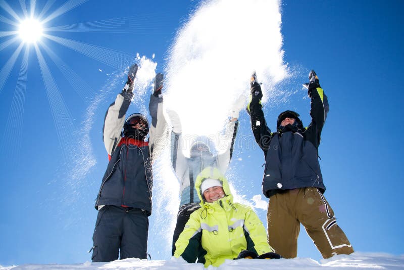 The happy group of people throws a snow