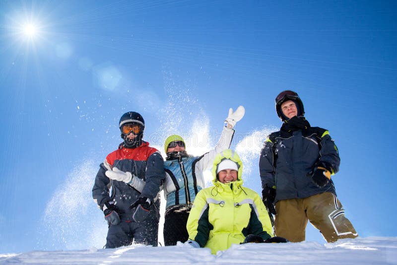 The happy group of people throws a snow