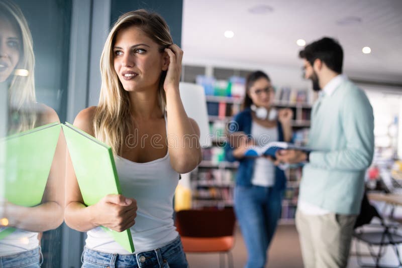 Happy group of students studying and learning together in college stock images Happy group of students studying and learning together in college stock images