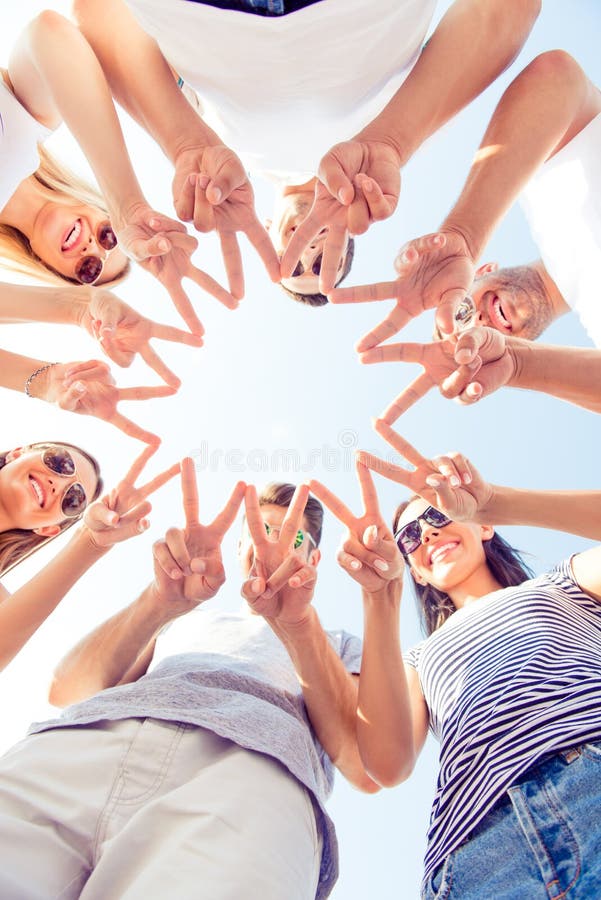 Happy group of young people showing star and peace gesture royalty free stock photo Happy group of young people showing star and peace gesture royalty free stock photo