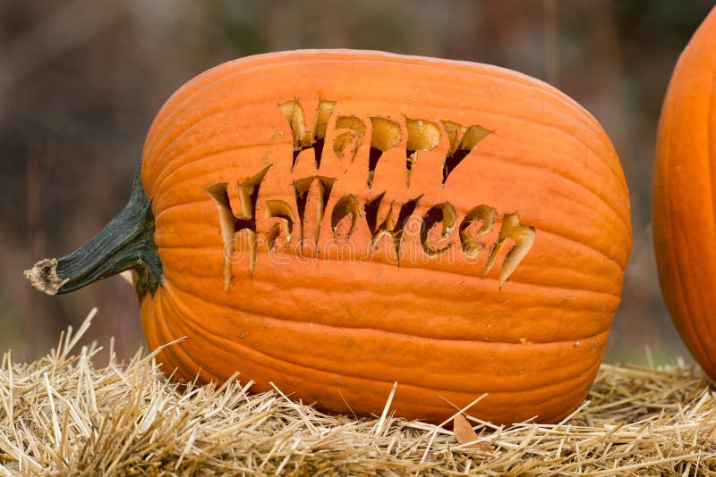 Carved pumpkin with Happy Halloween text