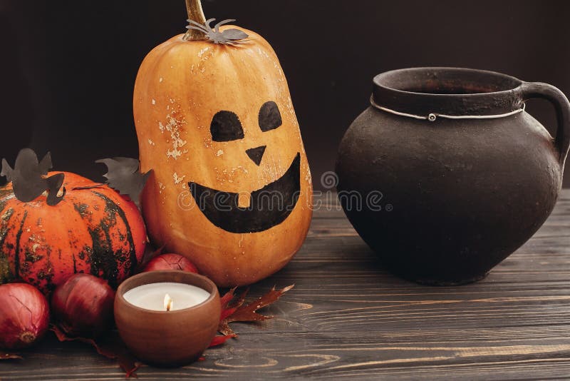 Happy Halloween concept. Pumpkins, jack-o-lantern, witch cauldron,bats, spider, candle light, autumn leaves on dark background. S royalty free stock photos Happy Halloween concept. Pumpkins, jack-o-lantern, witch cauldron,bats, spider, candle light, autumn leaves on dark background. S royalty free stock photos