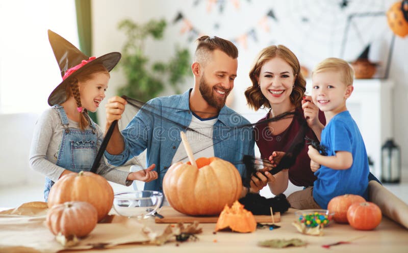 Happy Halloween! family mother father and children cut pumpkin for holiday at home royalty free stock photography Happy Halloween! family mother father and children cut pumpkin for holiday at home royalty free stock photography