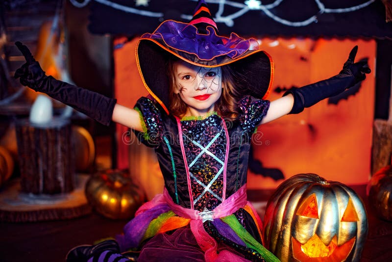 Happy Halloween. a Little Beautiful Girl in a Witch Costume Celebrates ...