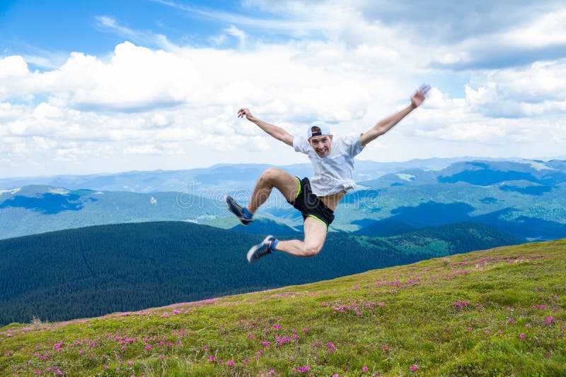 Happy handsome man tourist jump high into the sky for joy