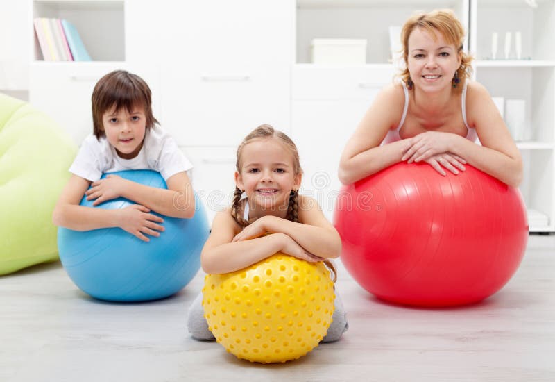 Happy healthy family relaxing in the middle of gymnastic exercise stock image Happy healthy family relaxing in the middle of gymnastic exercise stock image