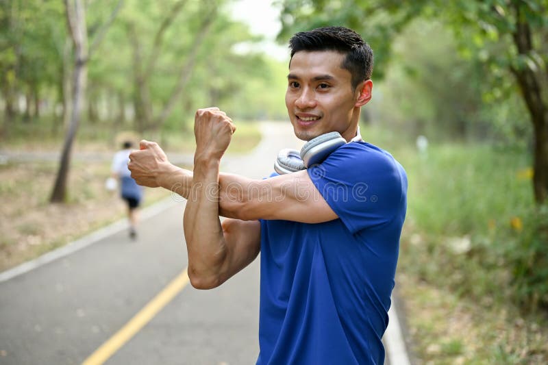 Happy Asian Man in Sportswear Stretching His Arms before Running at a ...