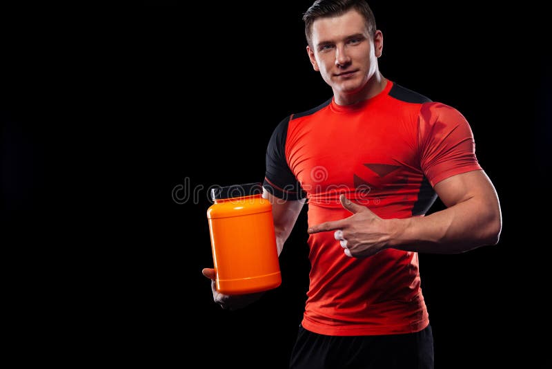 Happy and healthy muscular young fitness sports man with a jar of sports nutrition - protein, gainer and casein. Cheat