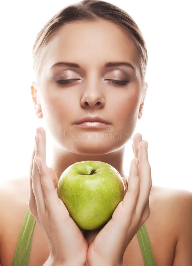 Happy healthy woman holding apple