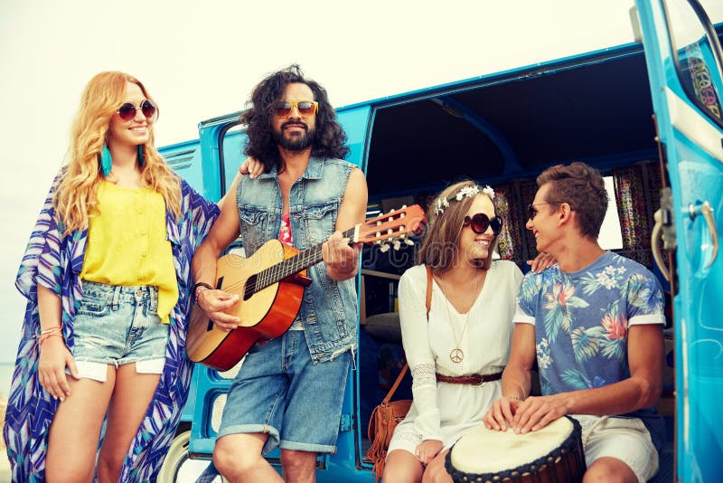 Happy hippie friends playing music over minivan