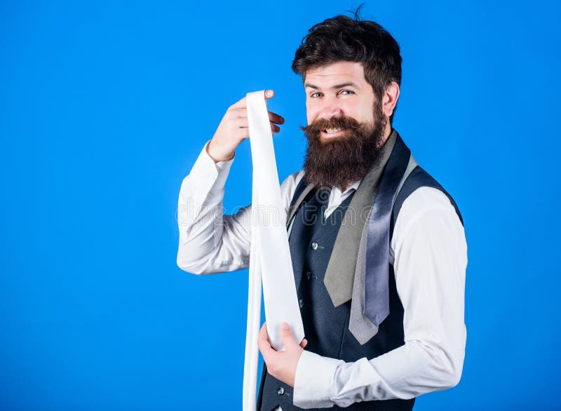 Happy with his choice. Sales manager offering a good choice of design neckties. Brutal hipster making a choice. Bearded man choosing tie from luxury collection. Choice concept, copy space.